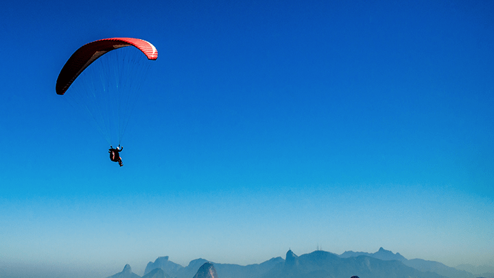 A parachutist against a blue sky