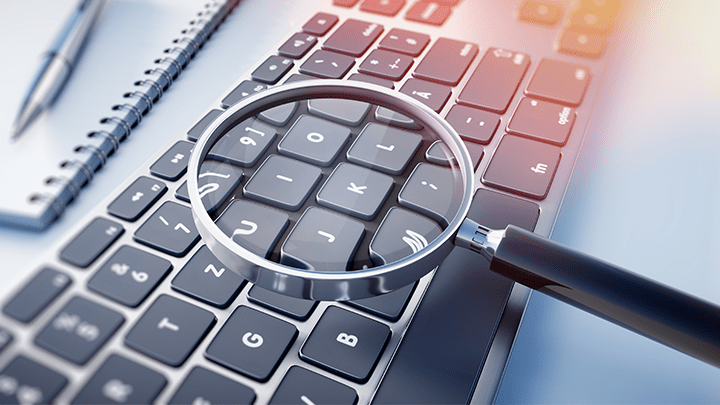 A magnifying glass over a keyboard